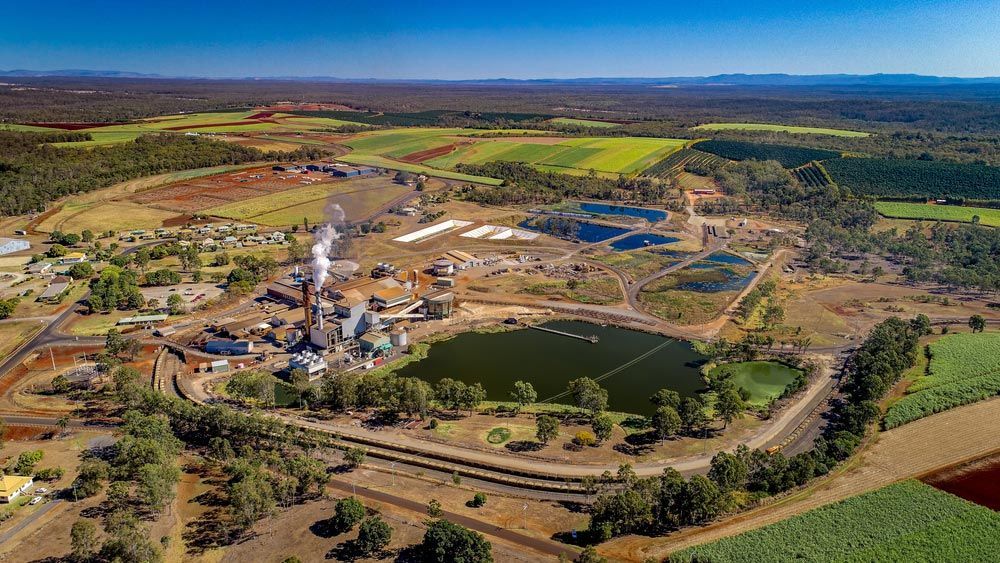 An Aerial View Of A Sugar Refinery Surrounded By Fields And Trees — CAL AUTO Mobile Roadworthys in Childers, QLD