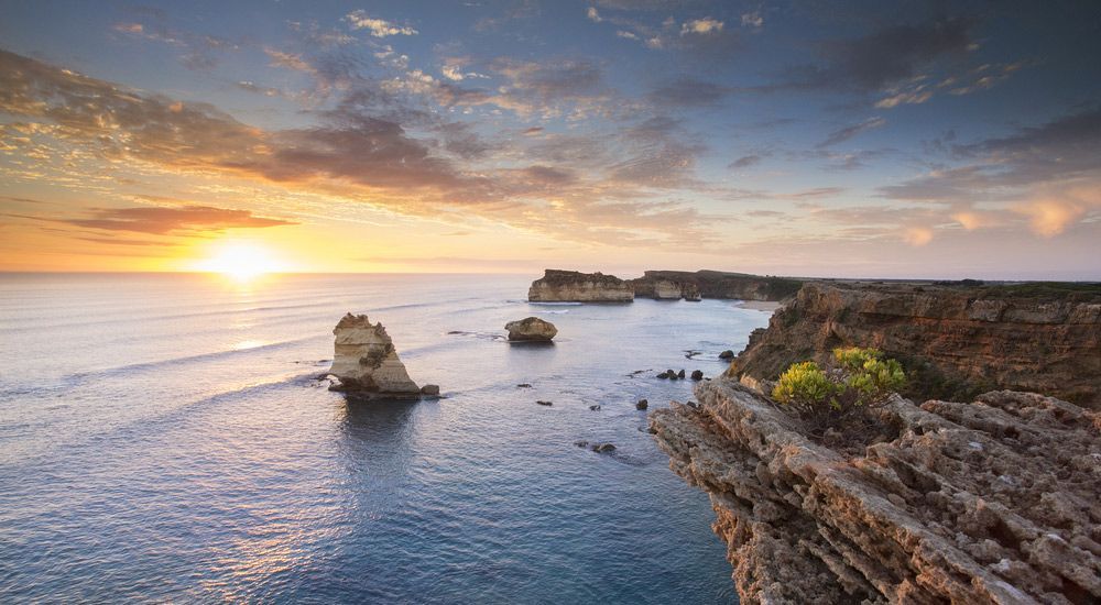 A Cliff Overlooking The Ocean With A Sunset In The Background — CAL AUTO Mobile Roadworthys in Childers, QLD
