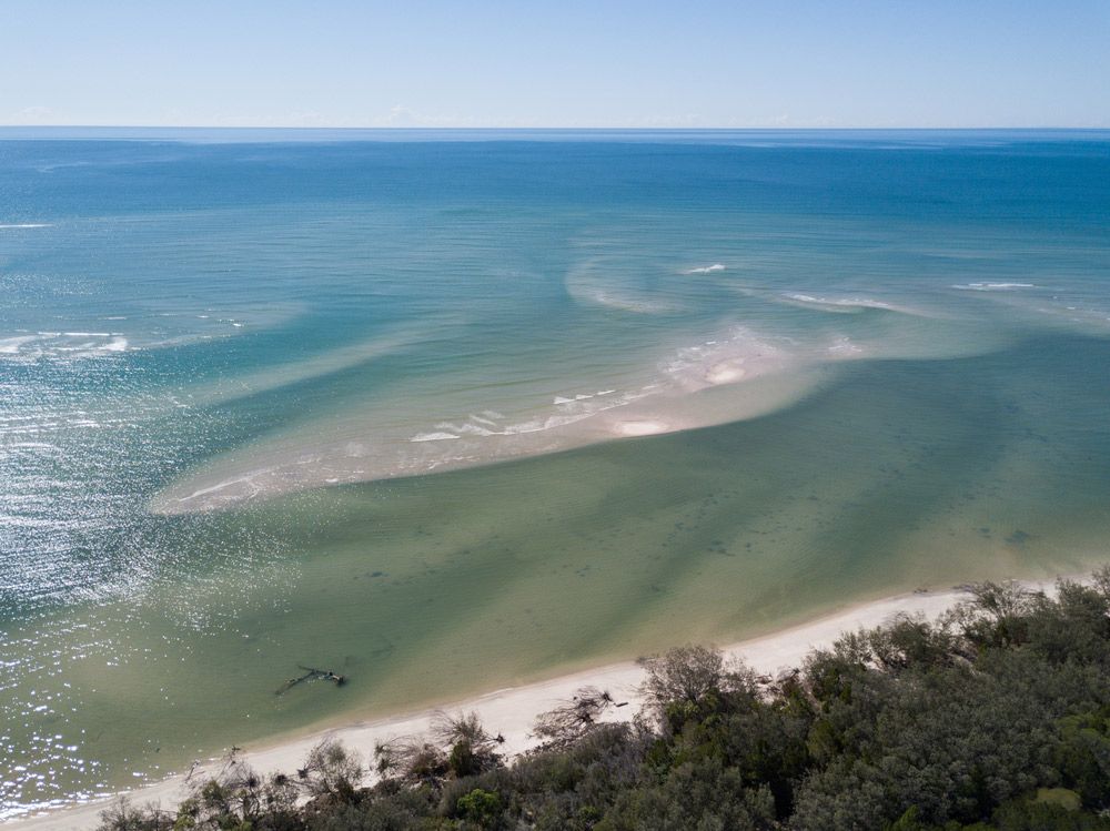 An Aerial View Of A Beach And The Ocean On A Sunny Day — CAL AUTO Mobile Roadworthys in Woodgate, QLD