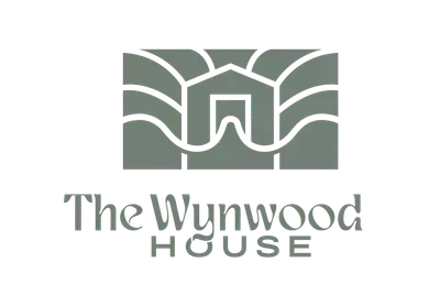 The wynwood house logo is a gray logo with a house on it.