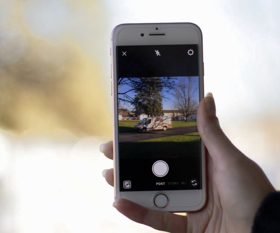 A person is holding a cell phone in their hand.