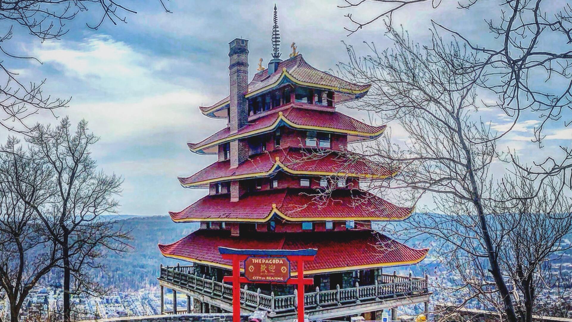 reading pa A painting of a pagoda surrounded by trees and a body of water.