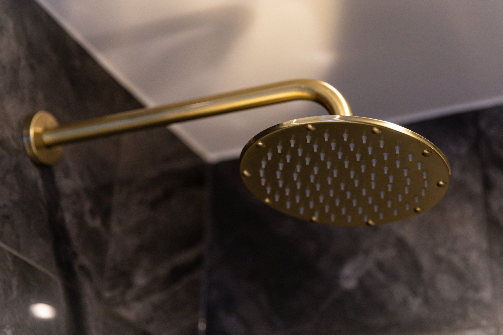 A close up of a gold faucet on a bathroom sink.