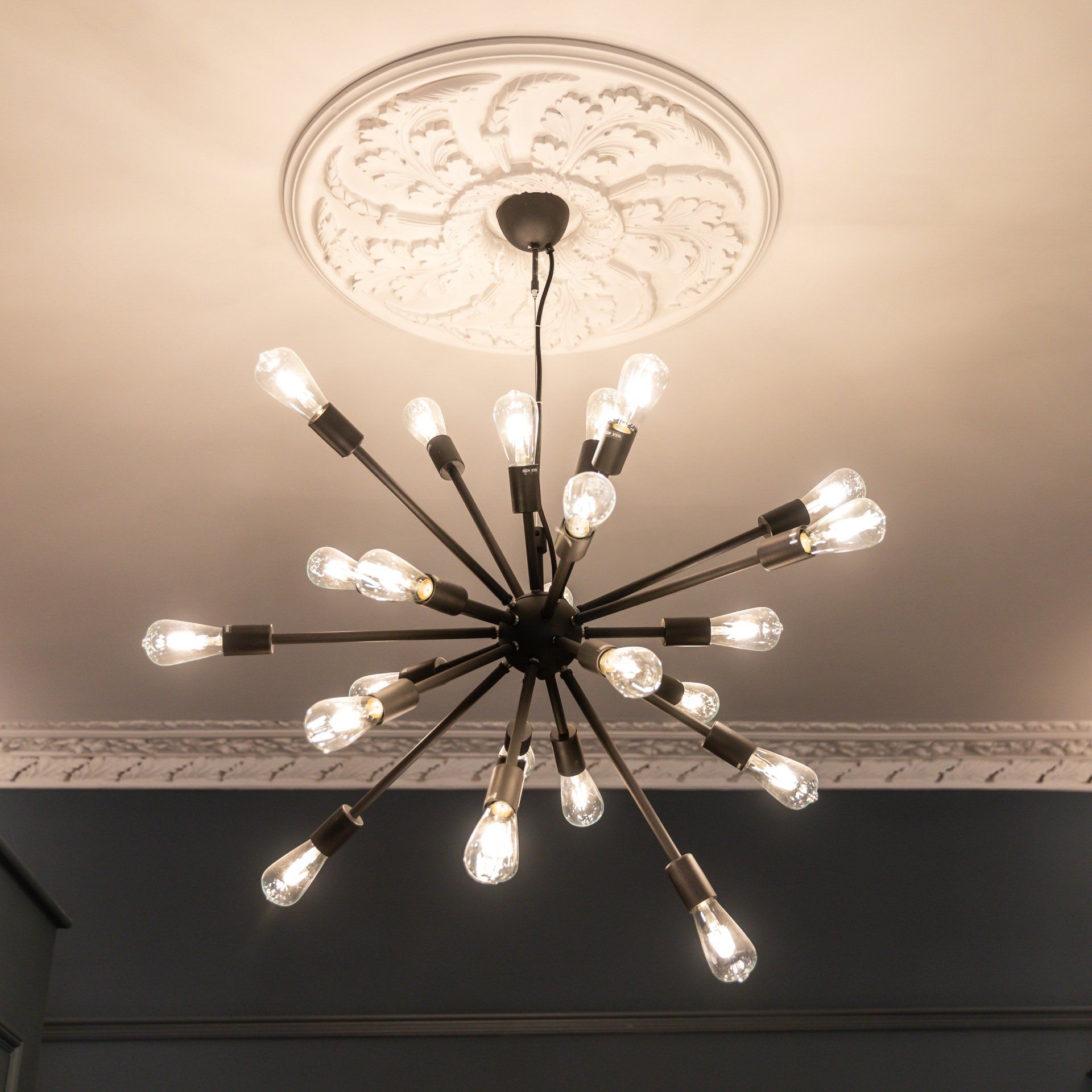 A chandelier with many light bulbs hanging from the ceiling