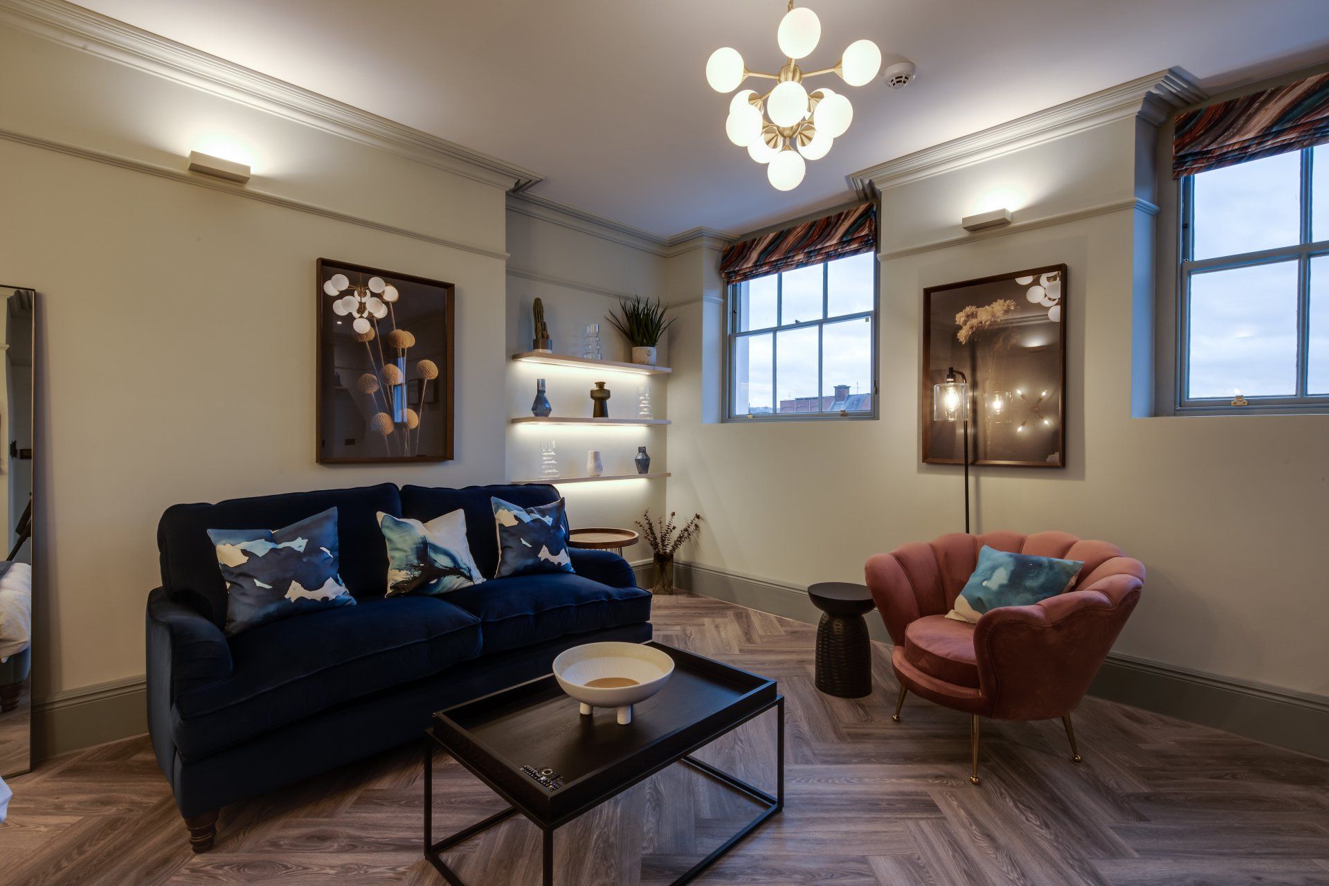 A living room with a couch , chair and coffee table.