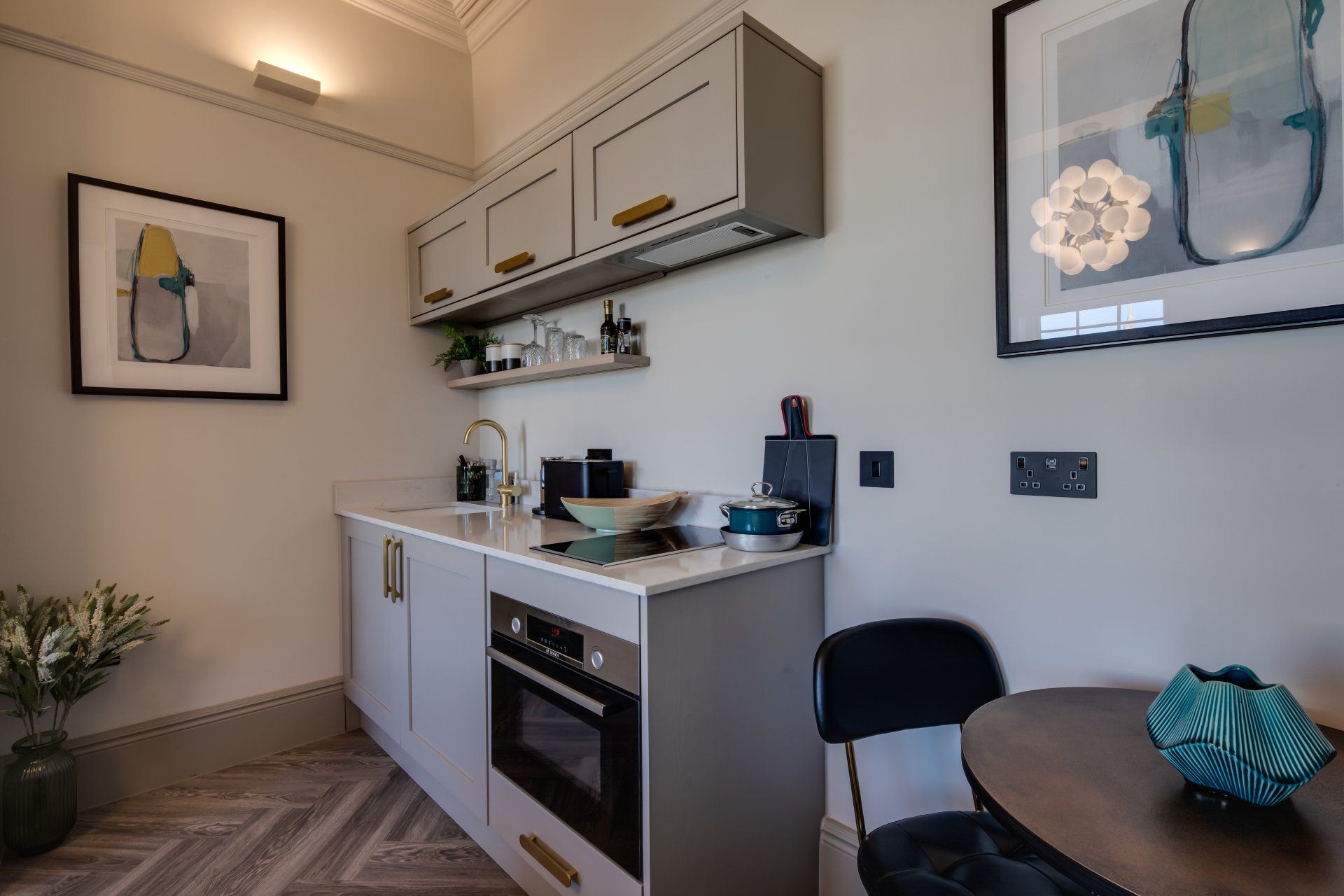A kitchen with a table and chairs and a picture on the wall.