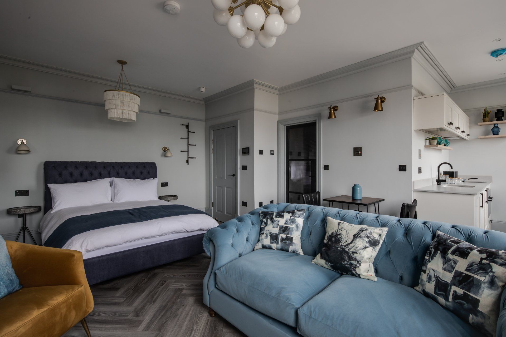 Open plan area with bed and sofa in a luxury serviced apartment from Neptune Apartments Cheltenham