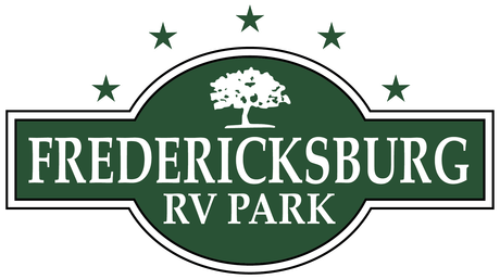 Logo for Fredericksburg RV Park: green oval with text, tree, and stars on a white background.
