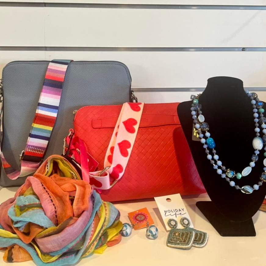A Red Purse With Hearts on the Strap Sits Next to a Gray Purse — Onyx Poppy Boutique in Sunshine Coast, QLD
