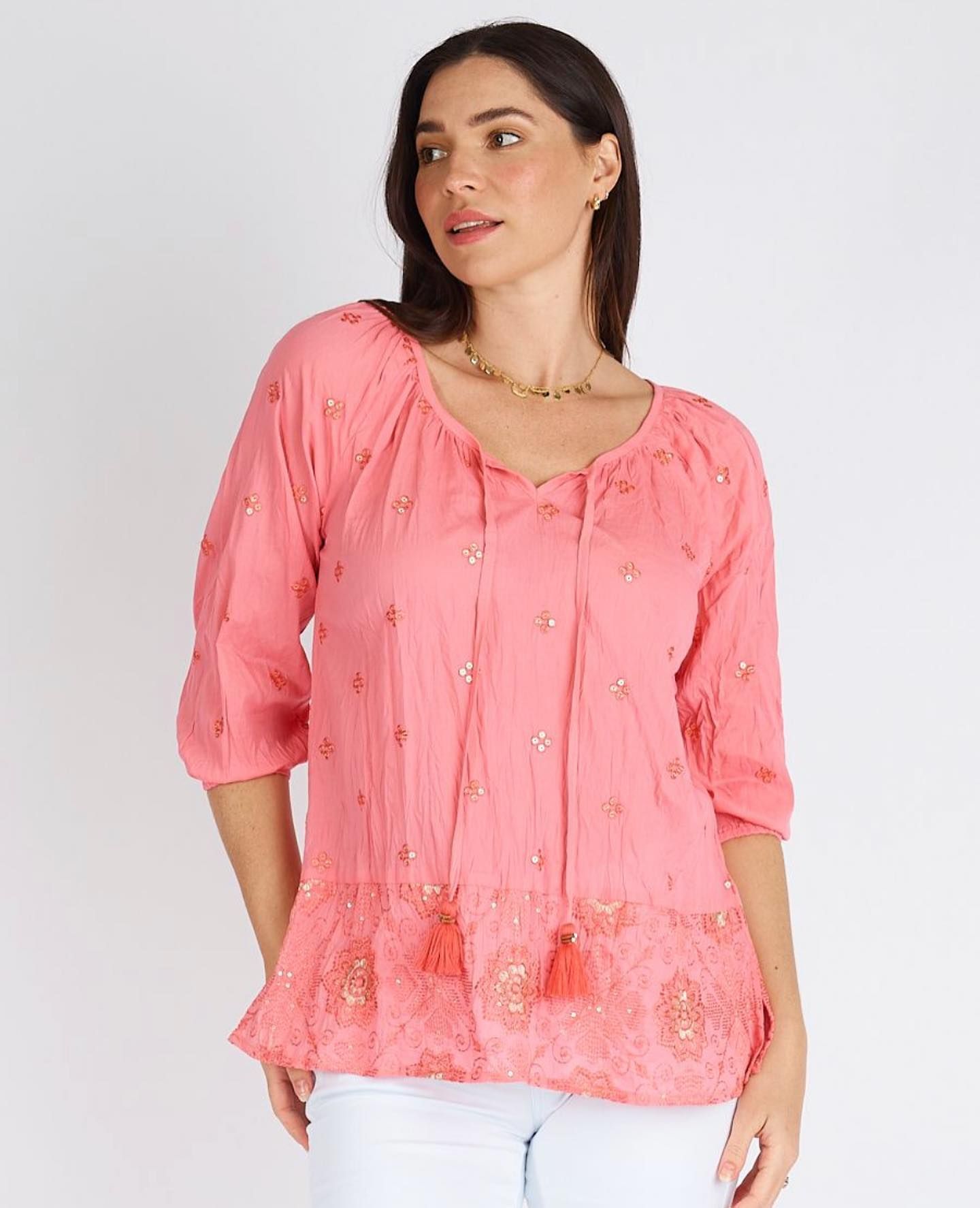 A Woman is Wearing a Pink Top With Tassels and White Pants — Onyx Poppy Boutique in Sunshine Coast, QLD