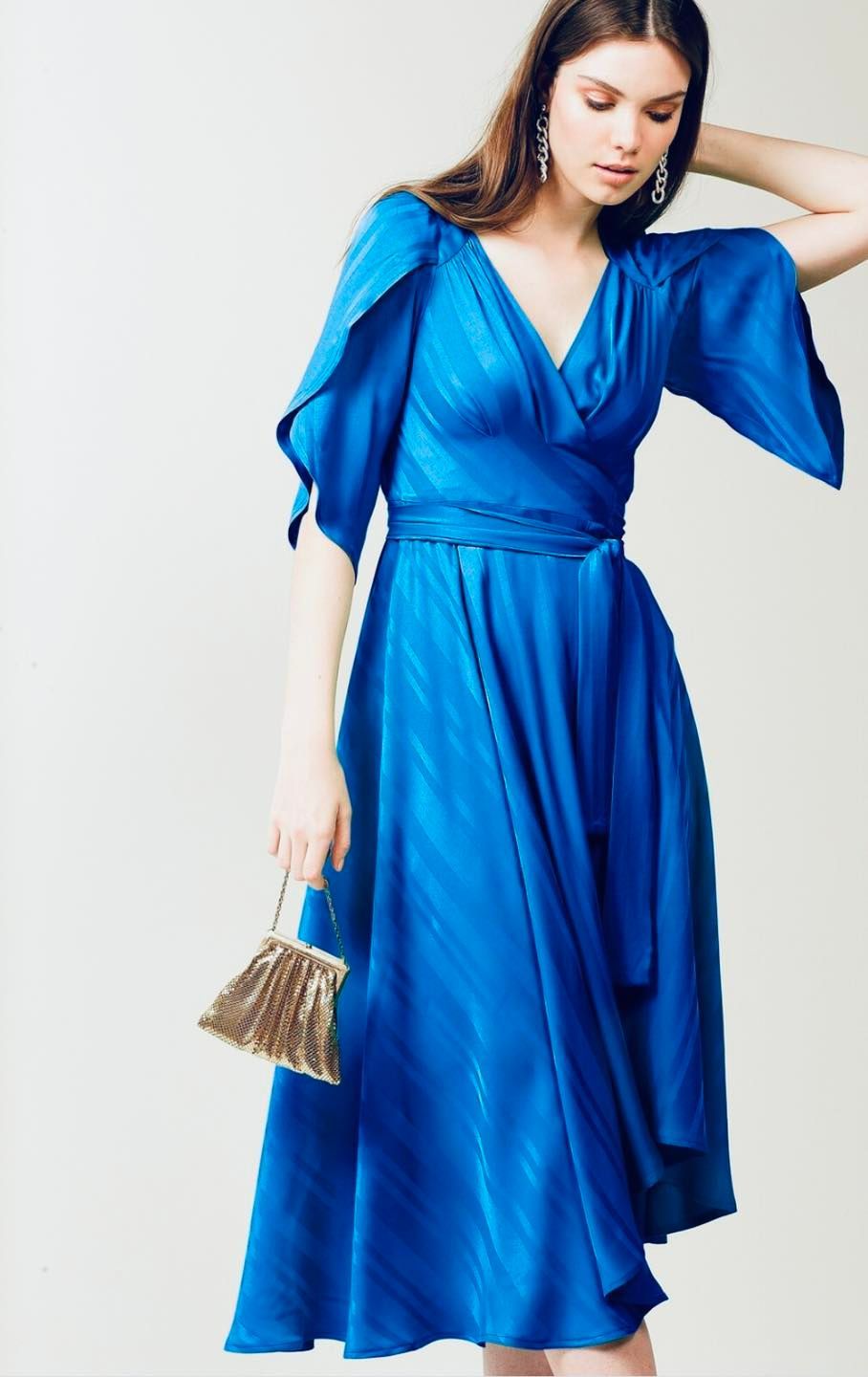 Woman in a Navy Blue Dress with Bell Sleeves Poses Smiling — Onyx Poppy Boutique in Sunshine Coast, QLD