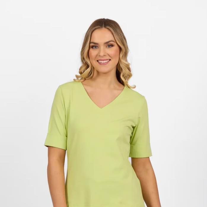 A Woman is Wearing a Green Shirt With a v-neck and Short Sleeves — Onyx Poppy Boutique in Sunshine Coast, QLD