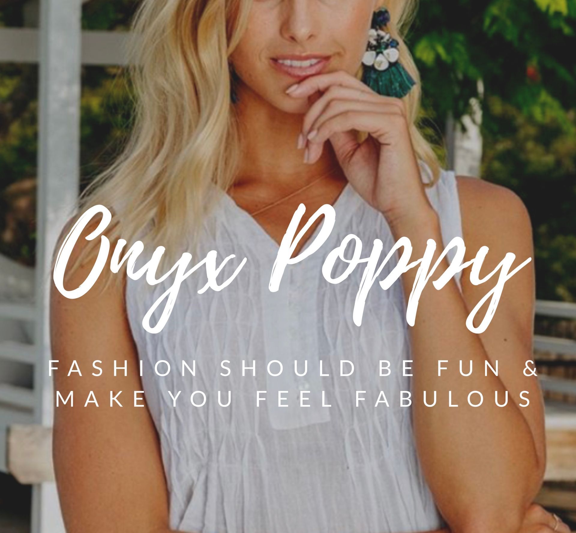 A Woman is Standing Next to a Sign That Says Onyx Poppy — Onyx Poppy Boutique in Buderim, QLD