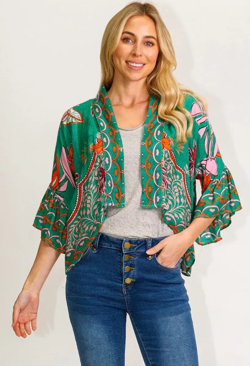 A Woman is Wearing a Green Kimono Jacket and Jeans — Onyx Poppy Boutique in Sunshine Coast, QLD