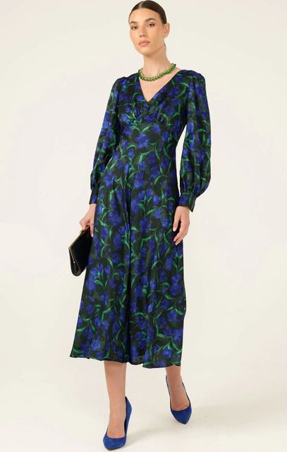 A Woman is Wearing a Green Floral Dress and Holding a Clutch — Onyx Poppy Boutique in Buderim, QLD
