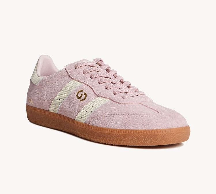 Pink suede sneakers with white stripes and a gum sole.