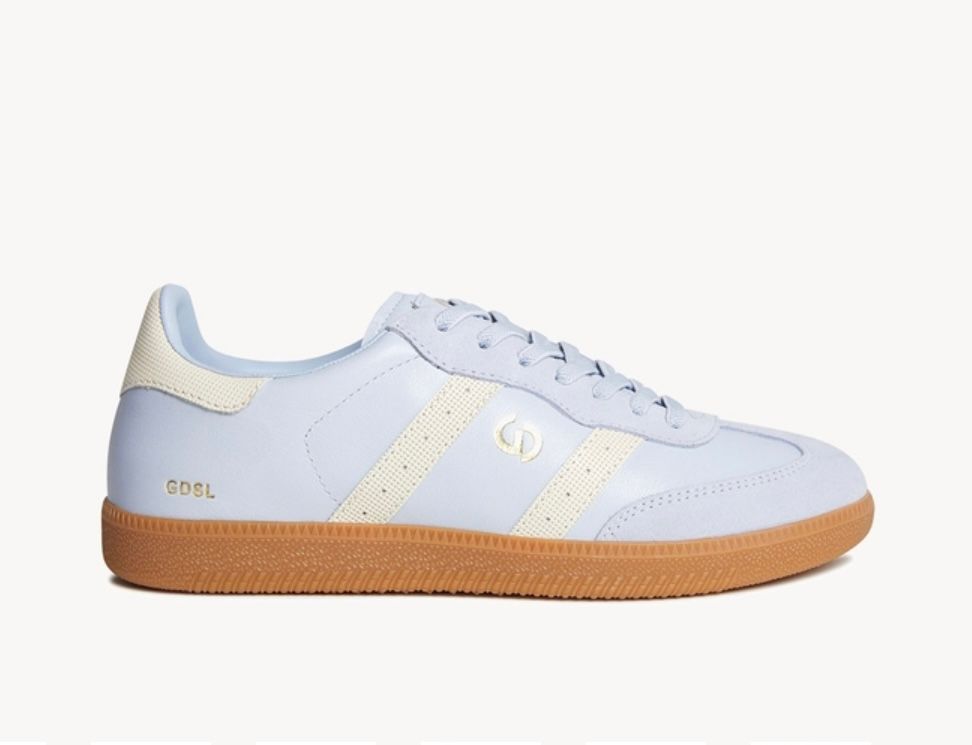 Light blue and cream sneakers with brown sole.