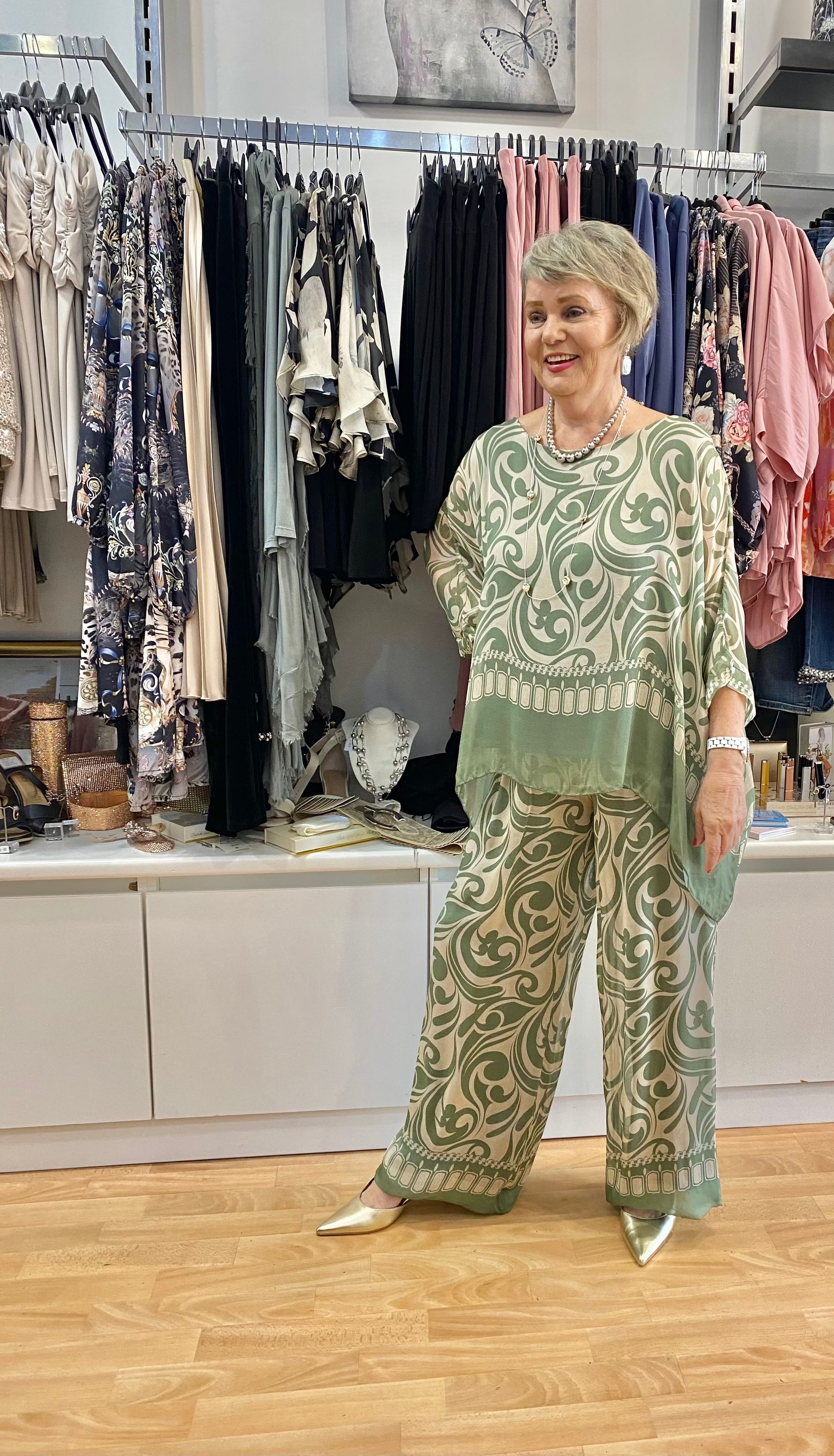 Woman in Green Patterned Pantsuit, Smiling, in a Clothing Store — Onyx Poppy Boutique in Buderim, QLD