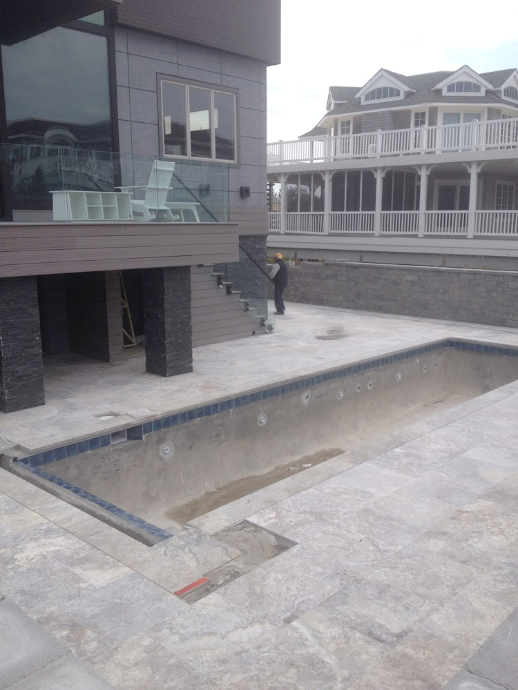 A large house with a swimming pool in front of it