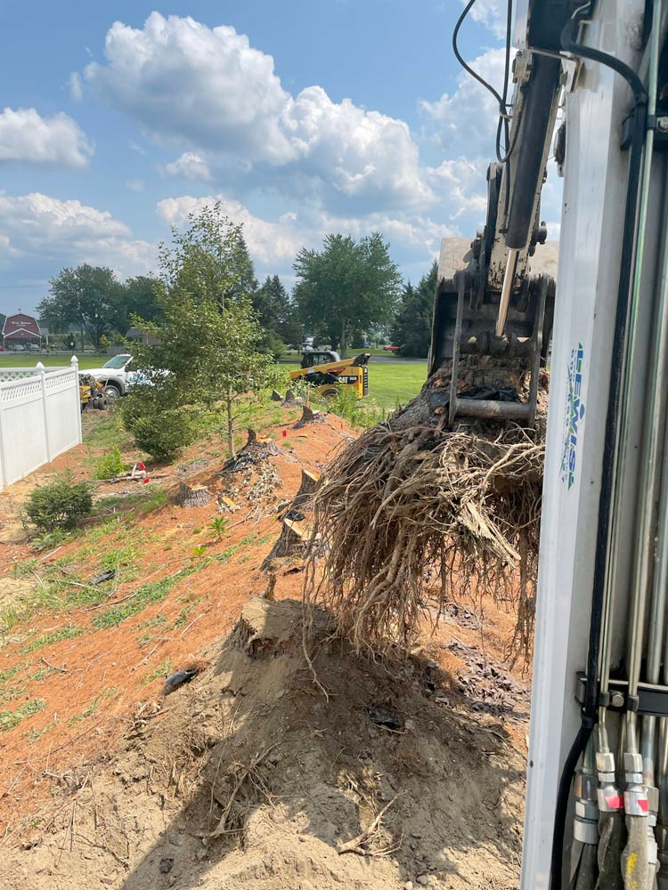 A large pile of dirt is being moved by a bulldozer.