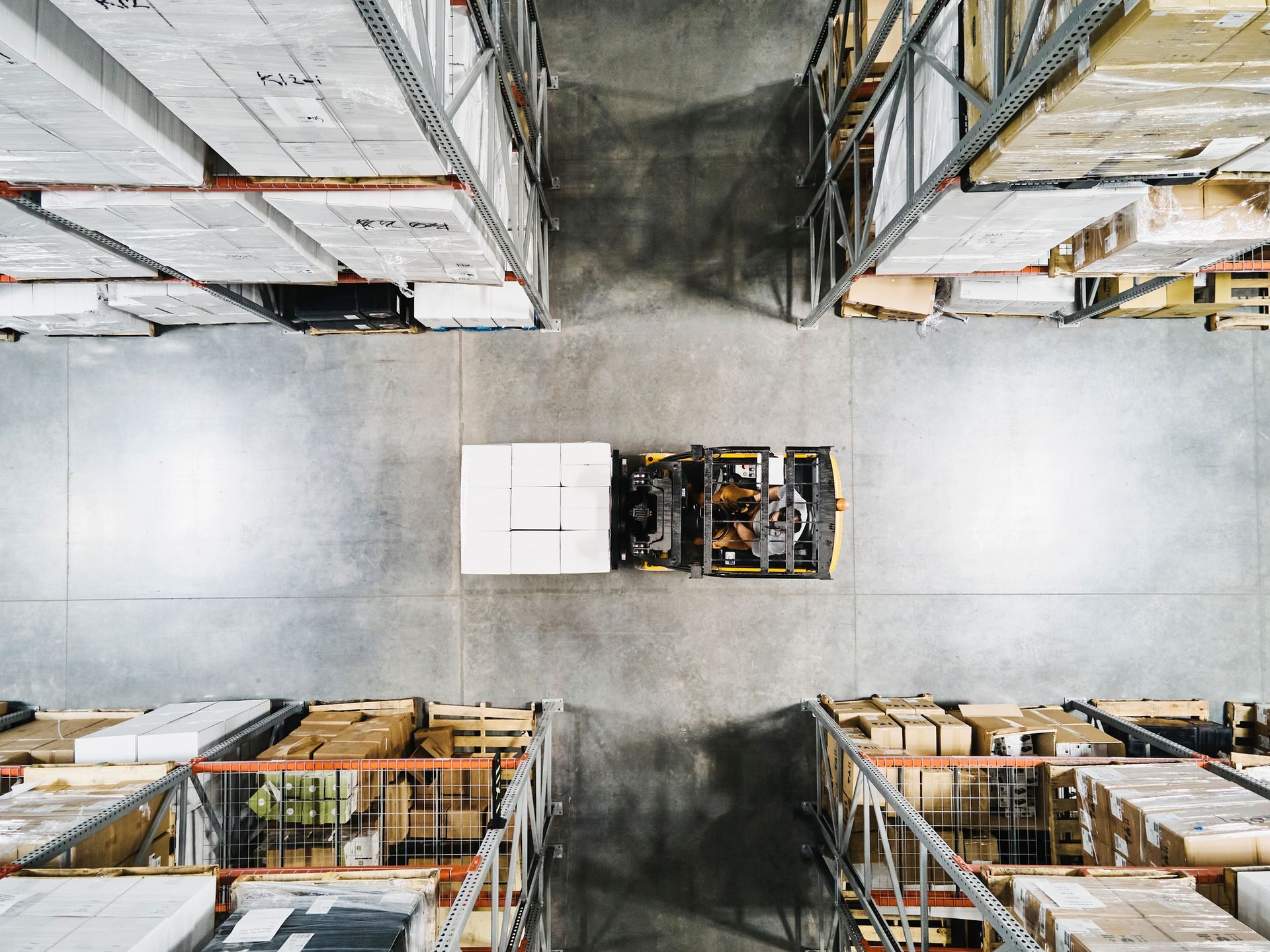 Top-down view of a warehouse with forklift transporting boxes, showing industrial supplies in Irving