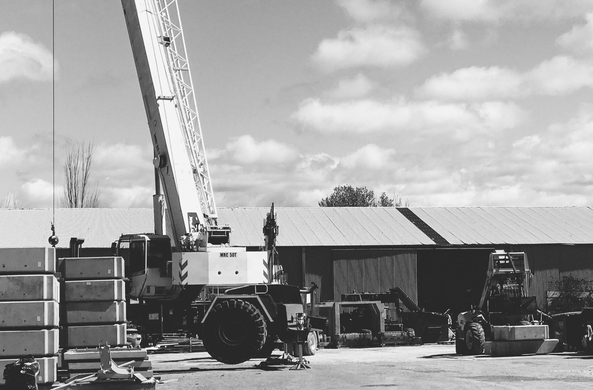 A Crane On A Farm Parked In front Of A Shed — Precast Concrete Solutions in Queanbeyan East, NSW
