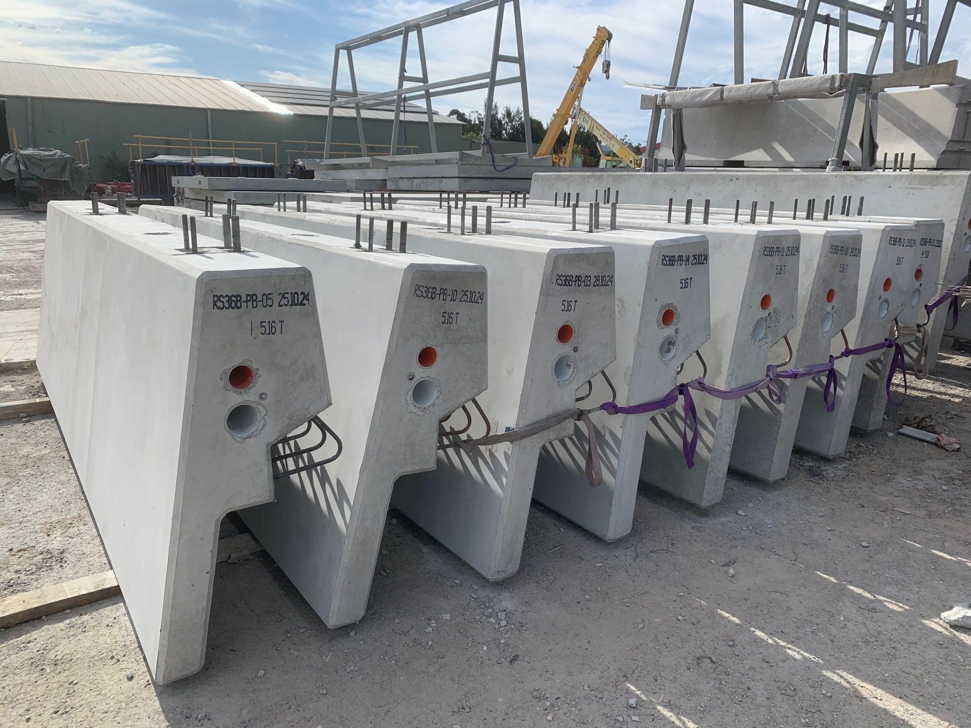 Bridge Parapets On Concrete With A Crane Behind Them — Precast Concrete Solutions in Queanbeyan East, NSW