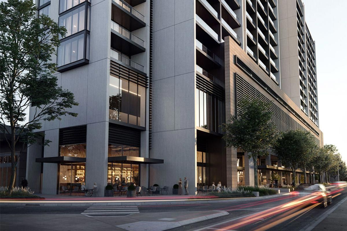 A Large Building with a lot of Windows is on the Corner of a Street — Precast Concrete Solutions in Queanbeyan East, NSW