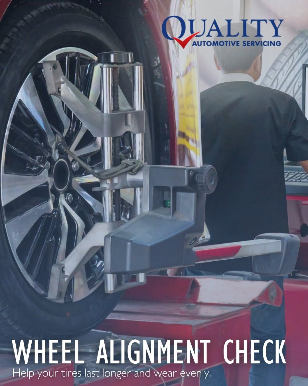 Wheel alignment check on a car at an auto service shop with red lift and logo text | Quality Automotive Servicing