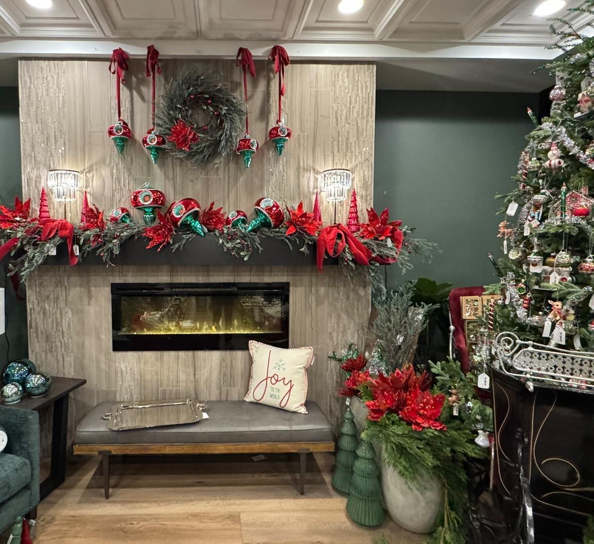 Festive living room with decorated fireplace, Christmas garland, and lit tree