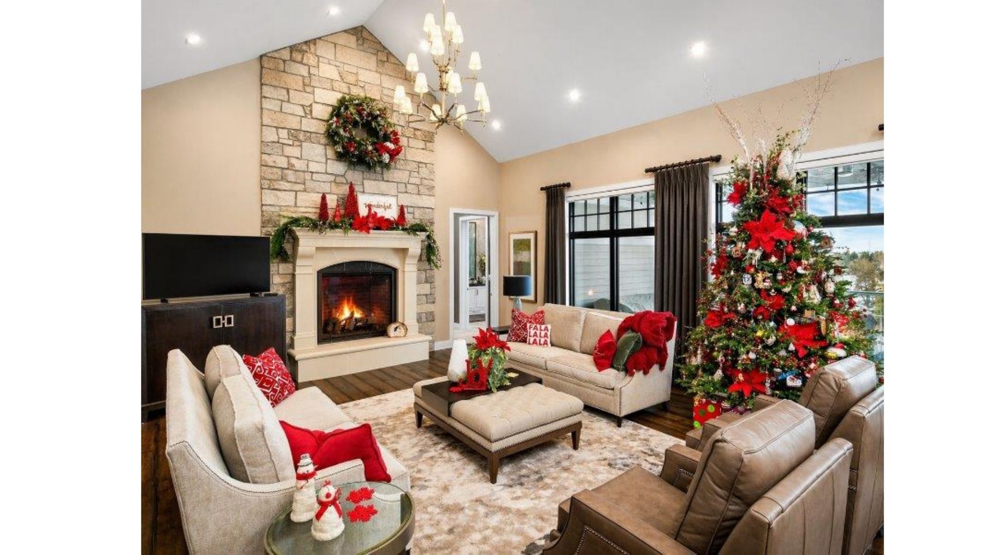 Cozy living room with fireplace, sofas, and a decorated Christmas tree by the window.