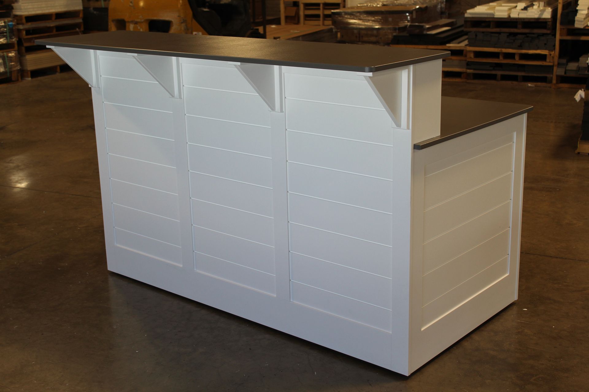 White and black bar with horizontal panel detailing and a raised section.