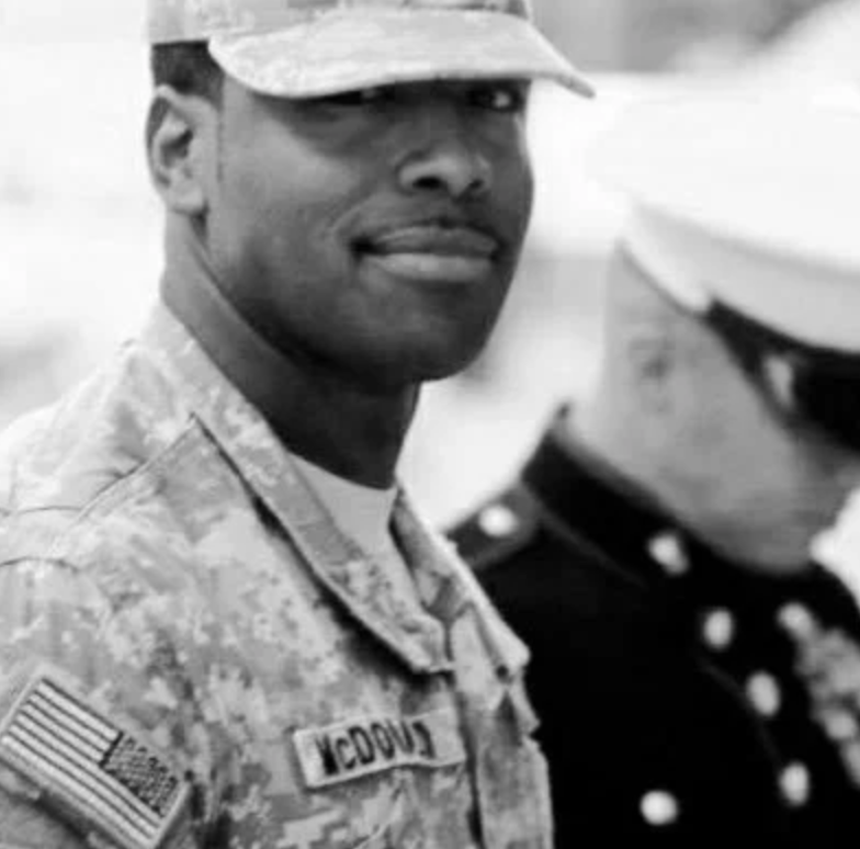 A black and white photo of a man in a military uniform.