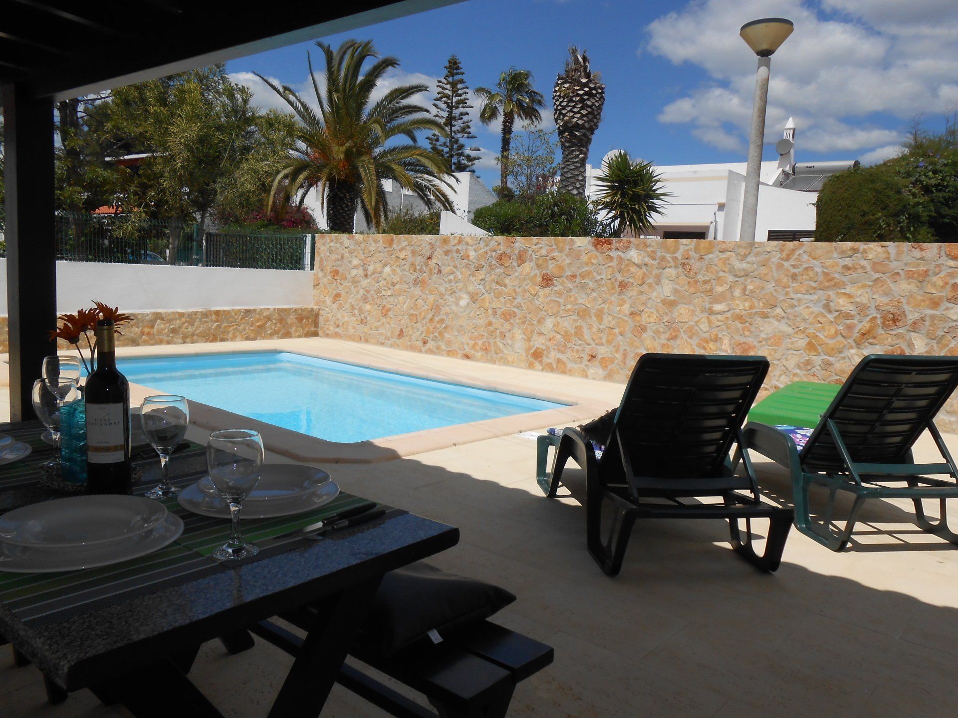 Impression of Villa Concha with pool, chair and wall of bricks