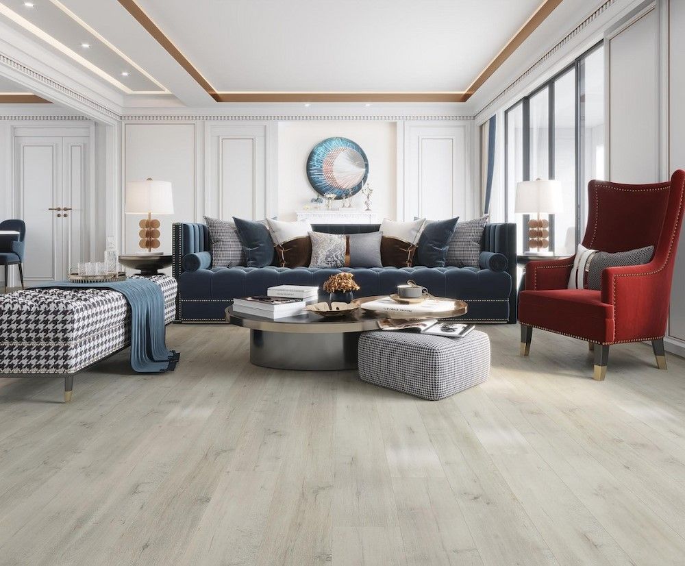 A Luxurious Living Room With Light Wood Floors, and a Blue Velvet Sofa — AGM Flooring & Tiling in Hidden Valley, QLD