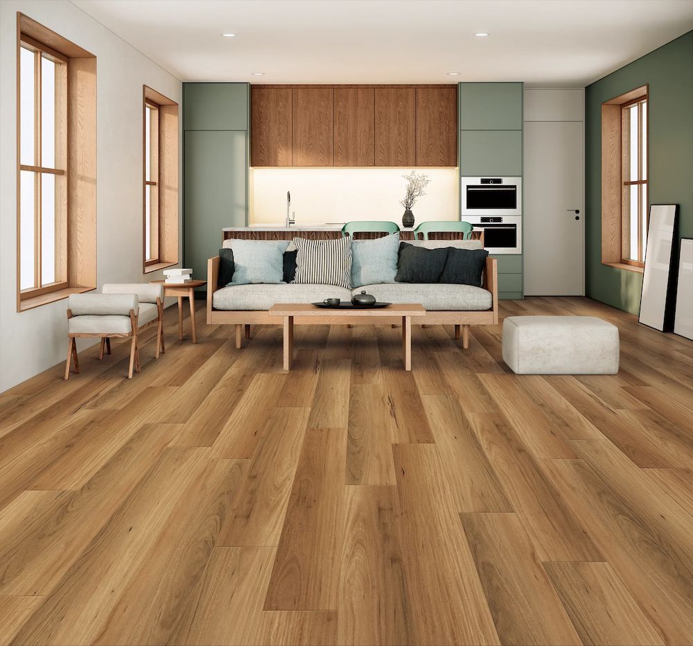 A Modern Living Room With Wood Floors, a Sofa, and Kitchen in the Background — AGM Flooring & Tiling in Hidden Valley, QLD