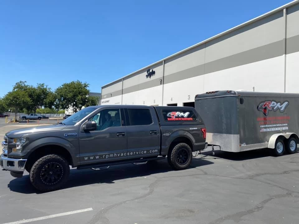 RPM HVAC commercial hvac contractors with service vehicle at business location
