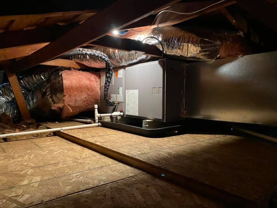 Residential HVAC system with air ductwork and ductwork installation in attic
