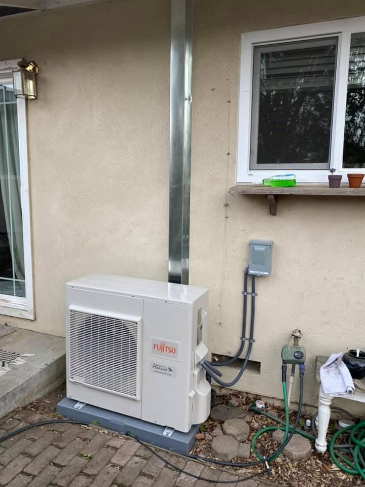 Fujitsu air conditioning installation with outdoor compressor unit and ductwork maintenance
