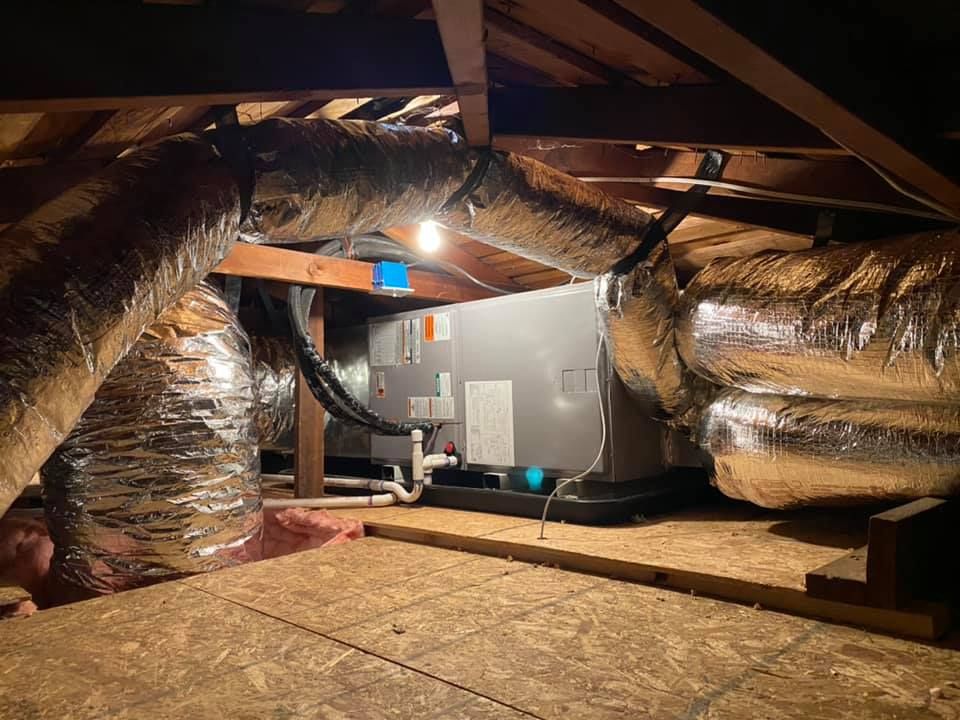 Residential HVAC system with air ductwork and ductwork installation in attic
