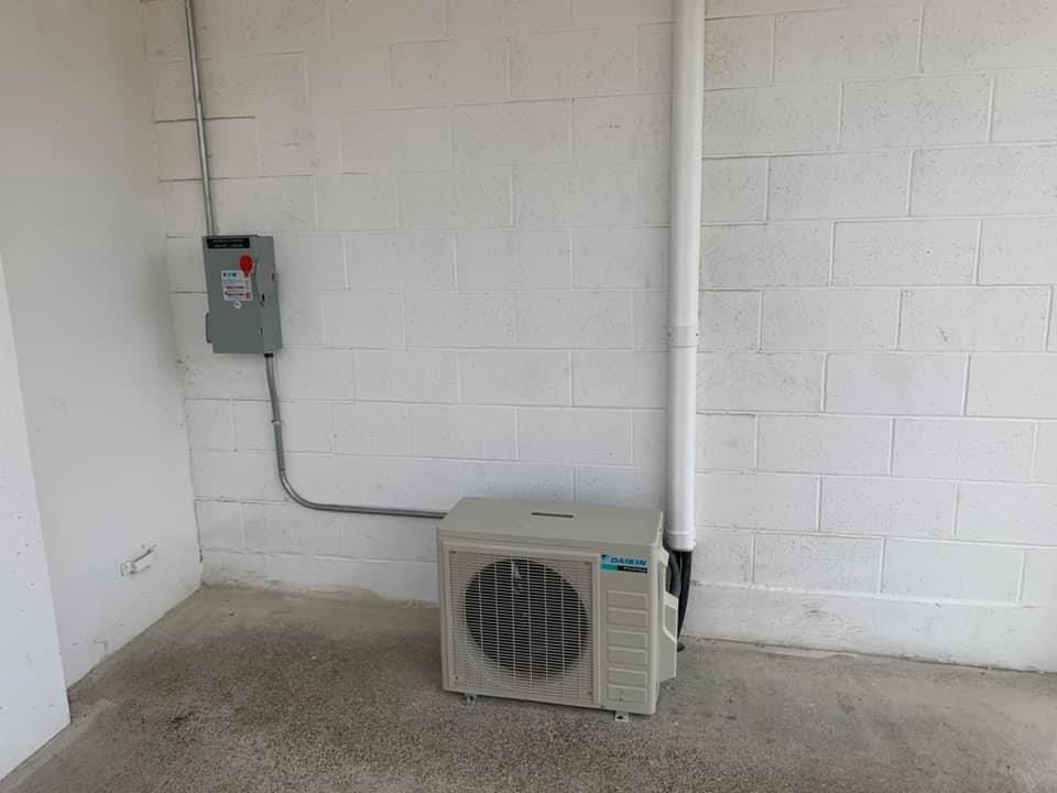 Daikin mini split condenser installed on concrete.
