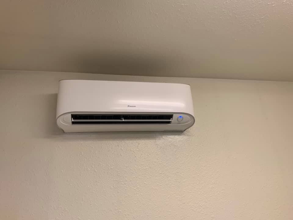 Daikin wall-mounted mini split AC unit indoors.
