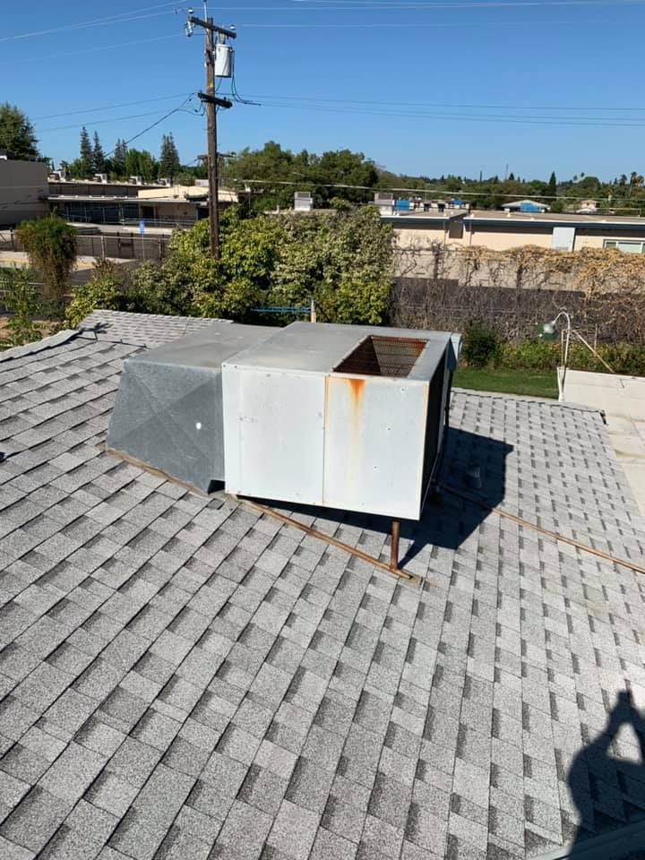 Old rooftop HVAC unit with visible rust on metal.
