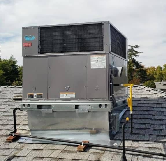 Bryant rooftop HVAC package unit on shingle roof.
