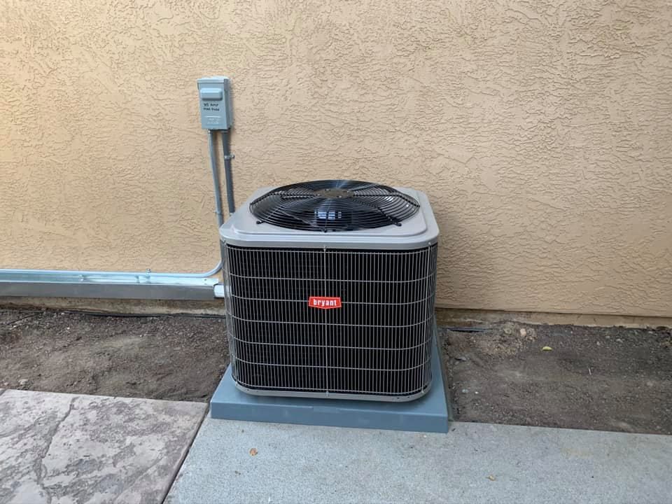 Bryant air conditioner installed on concrete pad outside home by RPM HVAC Service Inc.