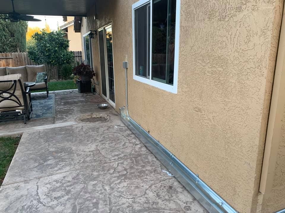 Exterior wall with new electrical conduit installed for AC unit by RPM HVAC Service Inc.