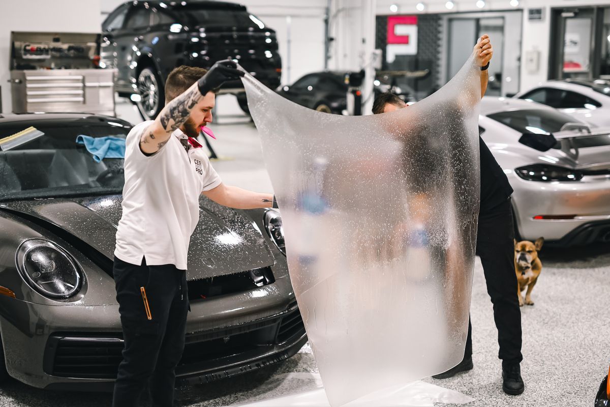 Paint protection film installation on a sports car