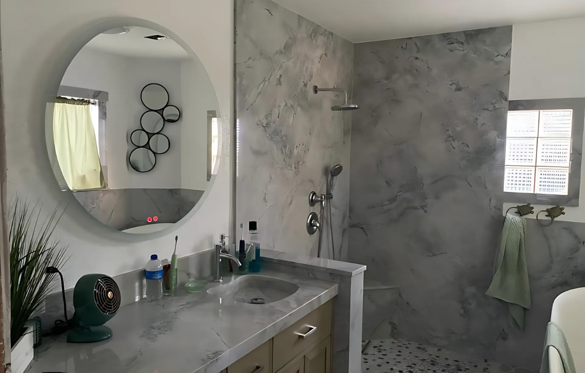 A bathroom with a walk in shower and two windows.