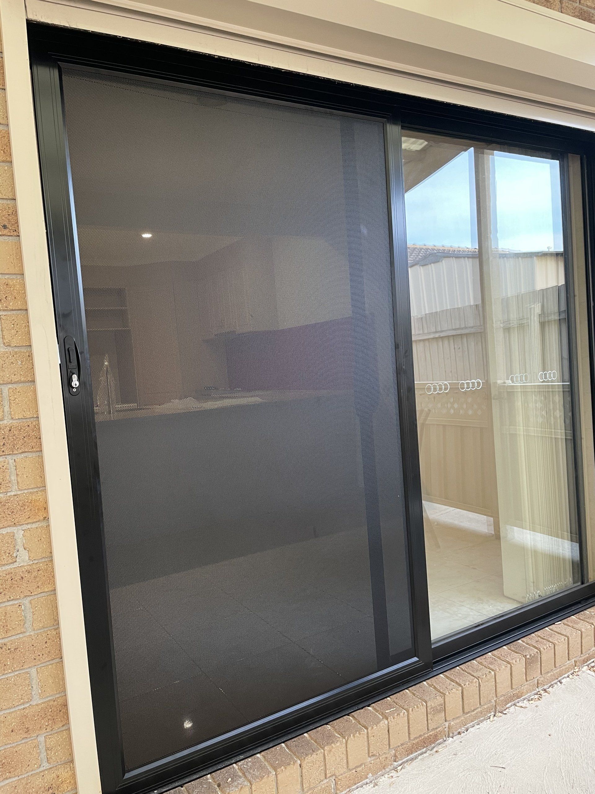A sliding Security Door with a screen on it.