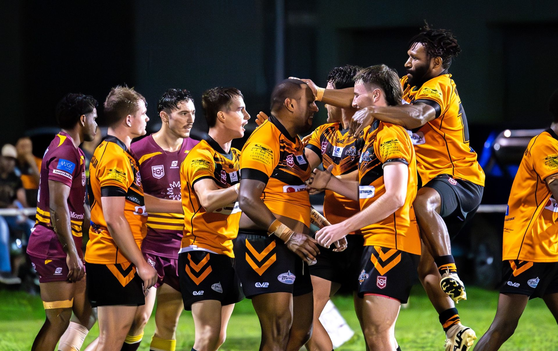Rugby Players in Orange and Black Uniforms — Amanda Jade Photography In Gordonvale, QLD